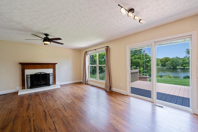 488 Springwood Lake Dr, Columbus, OH 43230 - unfurnished living room with a textured ceiling, ceiling fan, a water view, wood finished floors, and baseboards