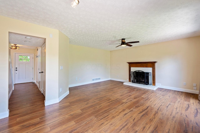 488 Springwood Lake Dr, Columbus, OH 43230 - unfurnished living room featuring wood finished floors, a ceiling fan, a textured ceiling, a fireplace, and baseboards