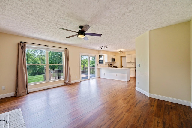 488 Springwood Lake Dr, Columbus, OH 43230 - unfurnished living room with ceiling fan, wood finished floors, baseboards, and a textured ceiling
