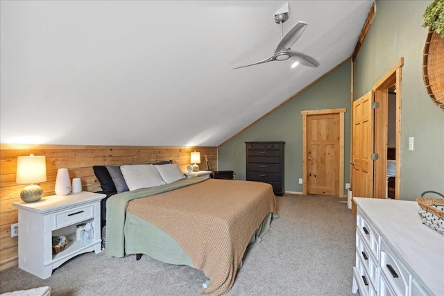 bedroom with a ceiling fan, light carpet, wooden walls, and lofted ceiling