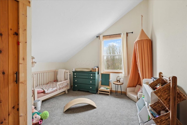 carpeted bedroom featuring a crib, baseboards, and lofted ceiling