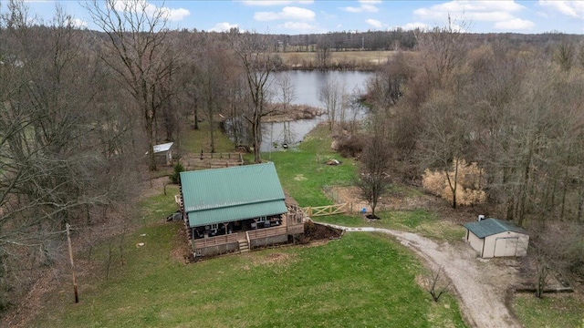 aerial view with a water view and a wooded view