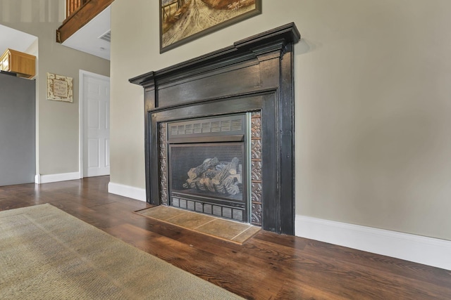 18738 State Route 327, Laurelville, OH 43135 - details featuring a tiled fireplace, visible vents, baseboards, and wood finished floors