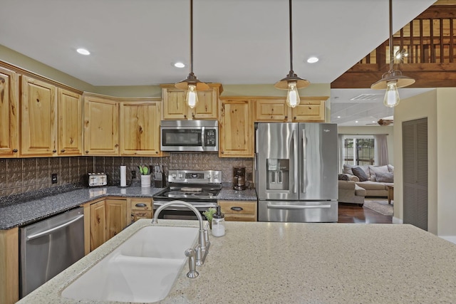 18738 State Route 327, Laurelville, OH 43135 - kitchen featuring decorative backsplash, dark stone counters, appliances with stainless steel finishes, a sink, and decorative light fixtures