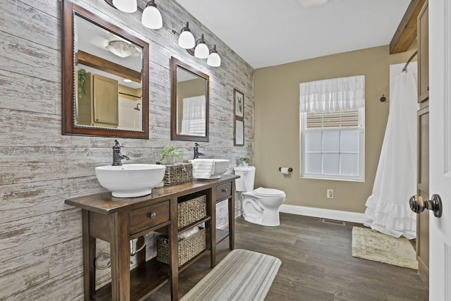 18738 State Route 327, Laurelville, OH 43135 - bathroom with toilet, a sink, wood finished floors, baseboards, and double vanity