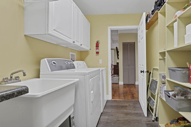 18738 State Route 327, Laurelville, OH 43135 - clothes washing area featuring washing machine and clothes dryer, cabinet space, dark wood-style floors, and a sink