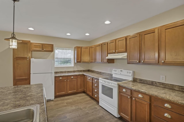 18738 State Route 327, Laurelville, OH 43135 - kitchen featuring a sink, brown cabinets, under cabinet range hood, white appliances, and dark countertops