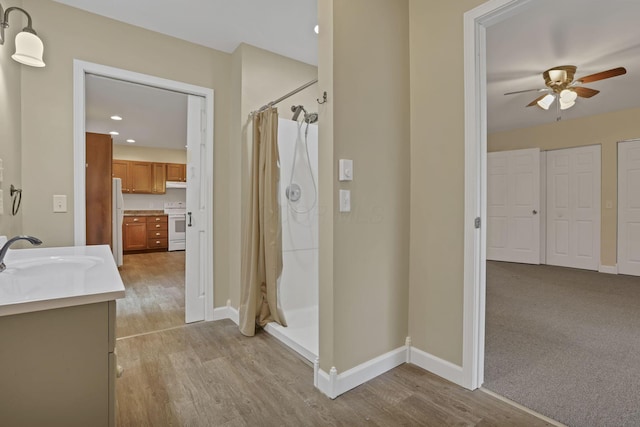 18738 State Route 327, Laurelville, OH 43135 - bathroom featuring vanity, baseboards, a shower stall, ceiling fan, and wood finished floors