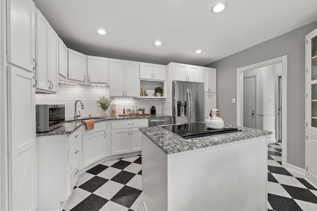 kitchen featuring open shelves, light floors, tasteful backsplash, a sink, and stainless steel appliances