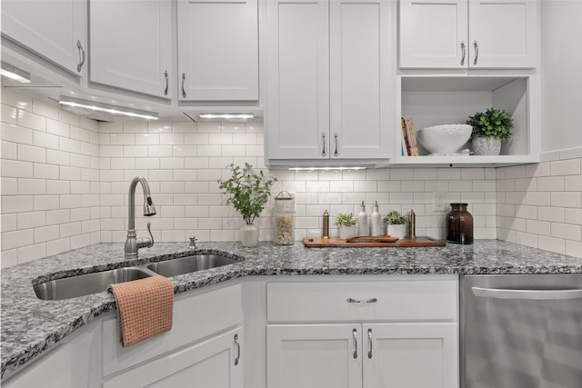 kitchen with white cabinets, open shelves, a sink, dishwasher, and decorative backsplash