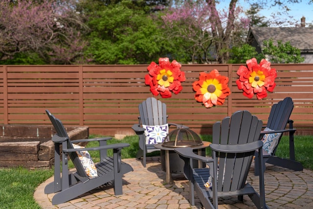 view of patio with a fire pit and fence