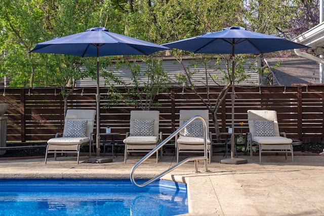 outdoor pool featuring a patio and fence