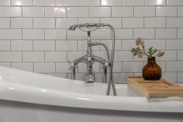 room details with decorative backsplash and a sink