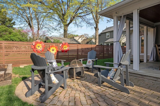 view of patio / terrace featuring fence and an outdoor fire pit