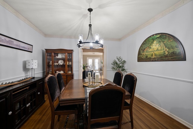 dining room with an inviting chandelier, ornamental molding, baseboards, dark wood-type flooring, and french doors