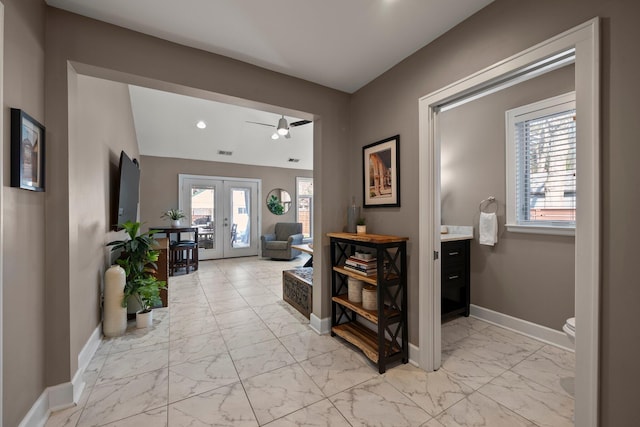 hall with baseboards, visible vents, french doors, and marble finish floor