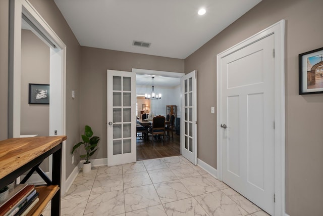 foyer featuring french doors, marble finish floor, baseboards, and visible vents