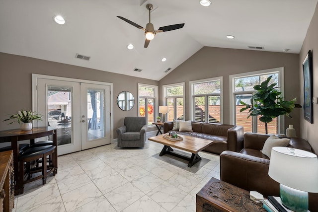 living area with vaulted ceiling, french doors, and visible vents