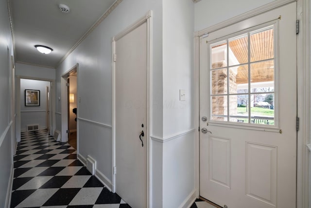entryway with dark floors, visible vents, and a healthy amount of sunlight