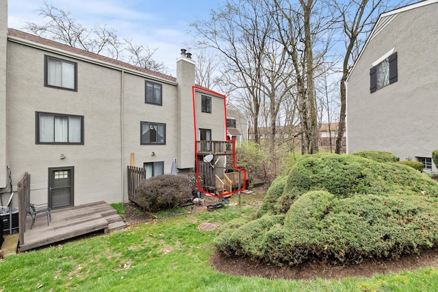 3018 Cooper Bluff Dr, Columbus, OH 43231 - rear view of property featuring stucco siding, a chimney, a yard, and a deck