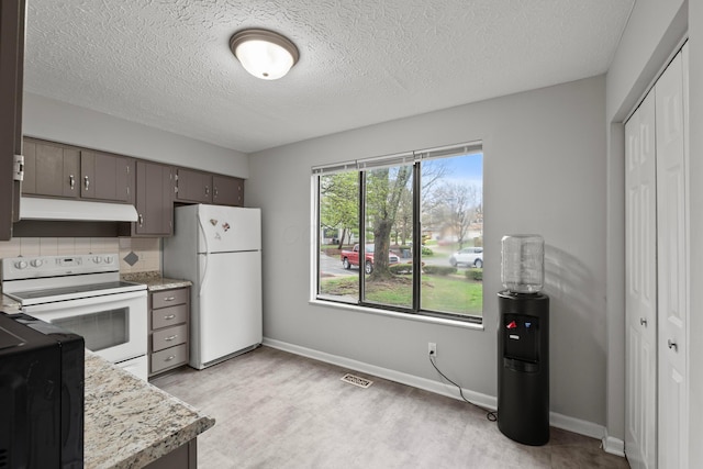 3018 Cooper Bluff Dr, Columbus, OH 43231 - kitchen with light countertops, light wood-type flooring, under cabinet range hood, white appliances, and visible vents