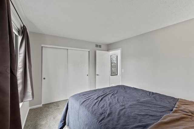 3018 Cooper Bluff Dr, Columbus, OH 43231 - carpeted bedroom with a closet, a textured ceiling, and visible vents