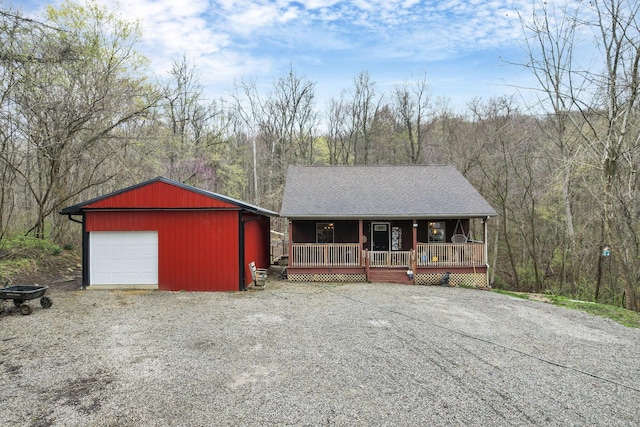 1335 Mingo Rd, Chillicothe, OH 45601 - rustic home with covered porch, driveway, and a wooded view