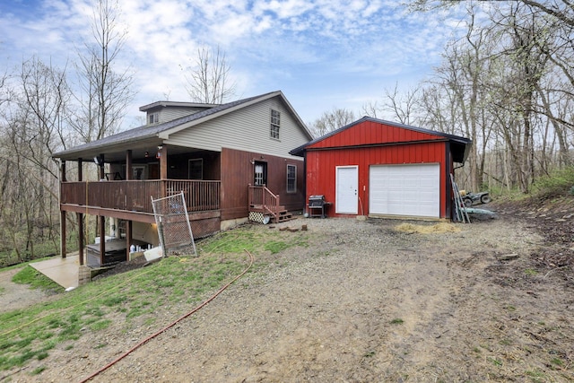1335 Mingo Rd, Chillicothe, OH 45601 - view of front of house with driveway, an outbuilding, a detached garage, and a porch