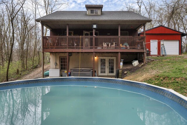 1335 Mingo Rd, Chillicothe, OH 45601 - rear view of house with a jacuzzi, french doors, an outdoor pool, a wooden deck, and an outbuilding