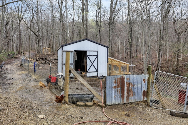 1335 Mingo Rd, Chillicothe, OH 45601 - view of shed with fence and a view of trees