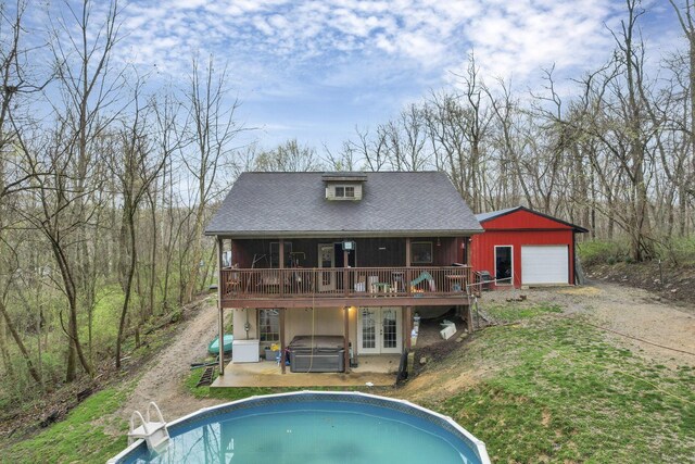 1335 Mingo Rd, Chillicothe, OH 45601 - back of property with a jacuzzi, a deck, dirt driveway, an outdoor pool, and an outbuilding