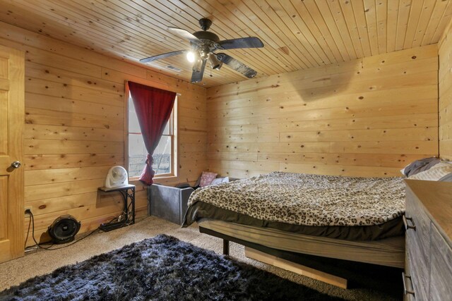 1335 Mingo Rd, Chillicothe, OH 45601 - carpeted bedroom featuring wood walls, wooden ceiling, and ceiling fan