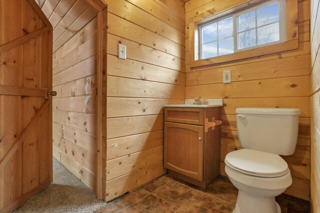 1335 Mingo Rd, Chillicothe, OH 45601 - half bath featuring wooden walls, toilet, vanity, and tile patterned flooring