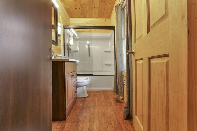 1335 Mingo Rd, Chillicothe, OH 45601 - full bath featuring hardwood / wood-style flooring, wooden ceiling, vanity, bath / shower combo with glass door, and toilet