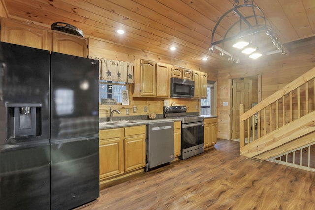1335 Mingo Rd, Chillicothe, OH 45601 - kitchen featuring stainless steel appliances, a sink, wooden ceiling, wood finished floors, and wood walls