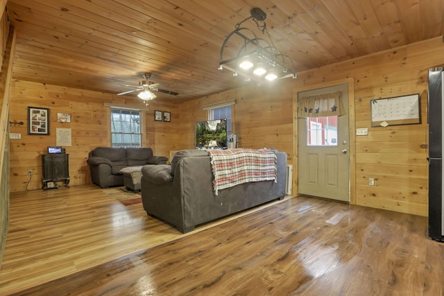 1335 Mingo Rd, Chillicothe, OH 45601 - living room featuring plenty of natural light, wood finished floors, a ceiling fan, wood ceiling, and wood walls