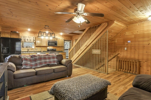 1335 Mingo Rd, Chillicothe, OH 45601 - living area with wood ceiling, ceiling fan, light wood-style flooring, and wood walls
