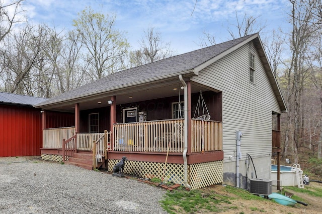 1335 Mingo Rd, Chillicothe, OH 45601 - view of front of house featuring a porch, roof with shingles, and central air condition unit