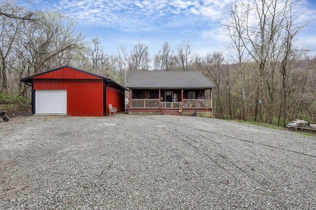 1335 Mingo Rd, Chillicothe, OH 45601 - view of front of house featuring a porch, a garage, driveway, and an outdoor structure