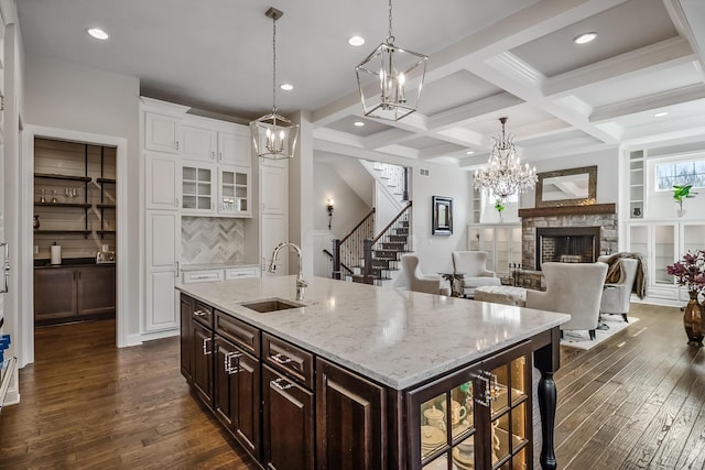 11061 Kingfisher Pl, Plain City, OH 43064 - kitchen with dark wood-style flooring, beam ceiling, a sink, coffered ceiling, and a notable chandelier