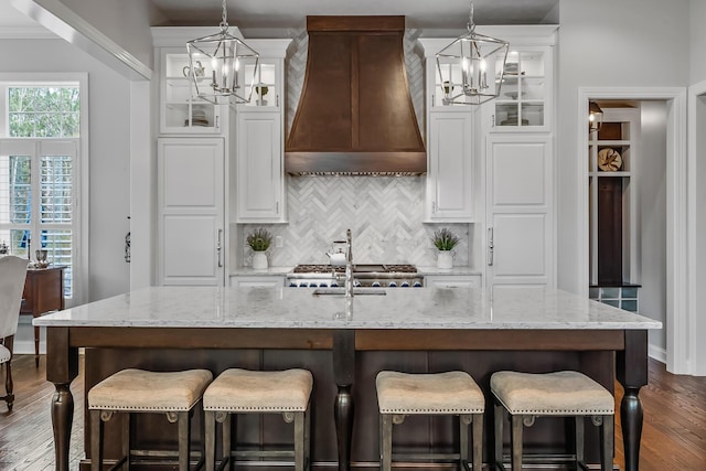 11061 Kingfisher Pl, Plain City, OH 43064 - kitchen with backsplash, a notable chandelier, custom exhaust hood, and dark wood finished floors