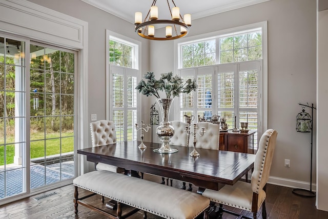 11061 Kingfisher Pl, Plain City, OH 43064 - dining area featuring ornamental molding, baseboards, hardwood / wood-style flooring, visible vents, and a notable chandelier