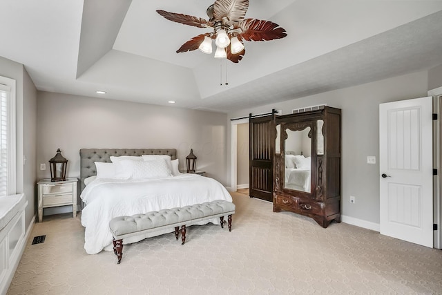 11061 Kingfisher Pl, Plain City, OH 43064 - bedroom with a tray ceiling, baseboards, a barn door, visible vents, and light carpet