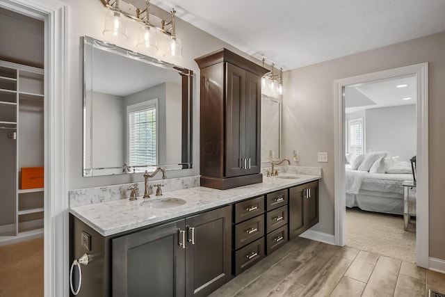 11061 Kingfisher Pl, Plain City, OH 43064 - full bath featuring connected bathroom, double vanity, baseboards, and a sink