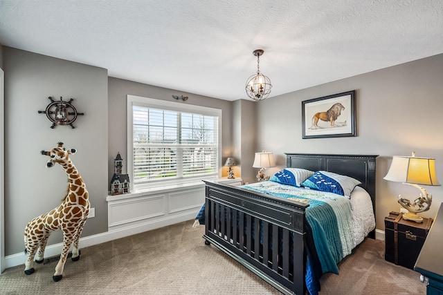 11061 Kingfisher Pl, Plain City, OH 43064 - carpeted bedroom featuring baseboards, a chandelier, and a textured ceiling