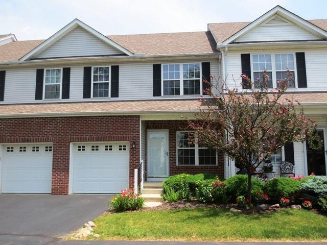 1218 Green Dr Unit 604, Columbus, OH 43230 - view of front of property featuring a garage, brick siding, and driveway