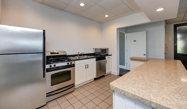 1620 E Broad St Unit 608, Columbus, OH 43203 - kitchen featuring light tile patterned floors, white cabinetry, appliances with stainless steel finishes, a sink, and baseboards