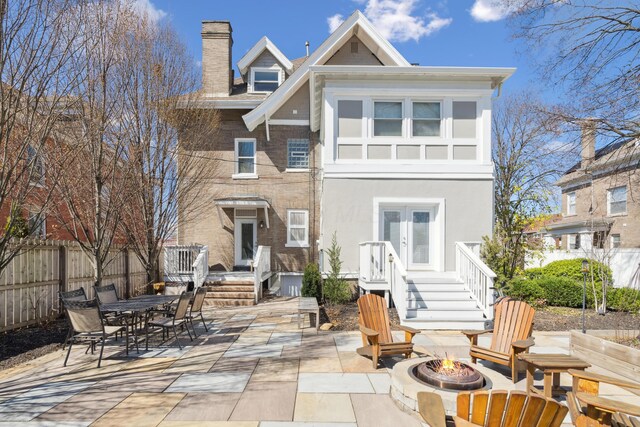 72 Miami Ave, Columbus, OH 43203 - back of house with french doors, an outdoor fire pit, a chimney, fence, and a patio
