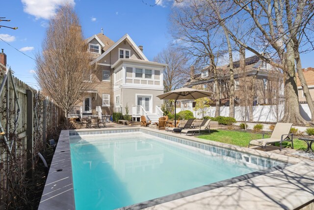 72 Miami Ave, Columbus, OH 43203 - rear view of house with a chimney, a fenced in pool, a fenced backyard, and a patio area