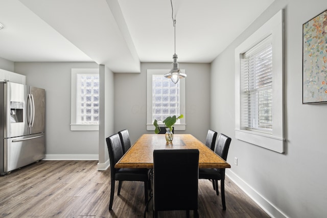 72 Miami Ave, Columbus, OH 43203 - dining room with baseboards, wood finished floors, and a healthy amount of sunlight